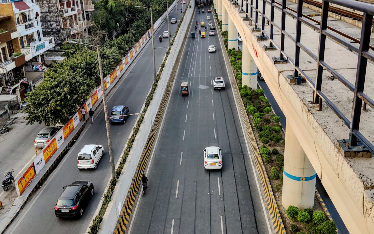 A wide city road running through a developing area